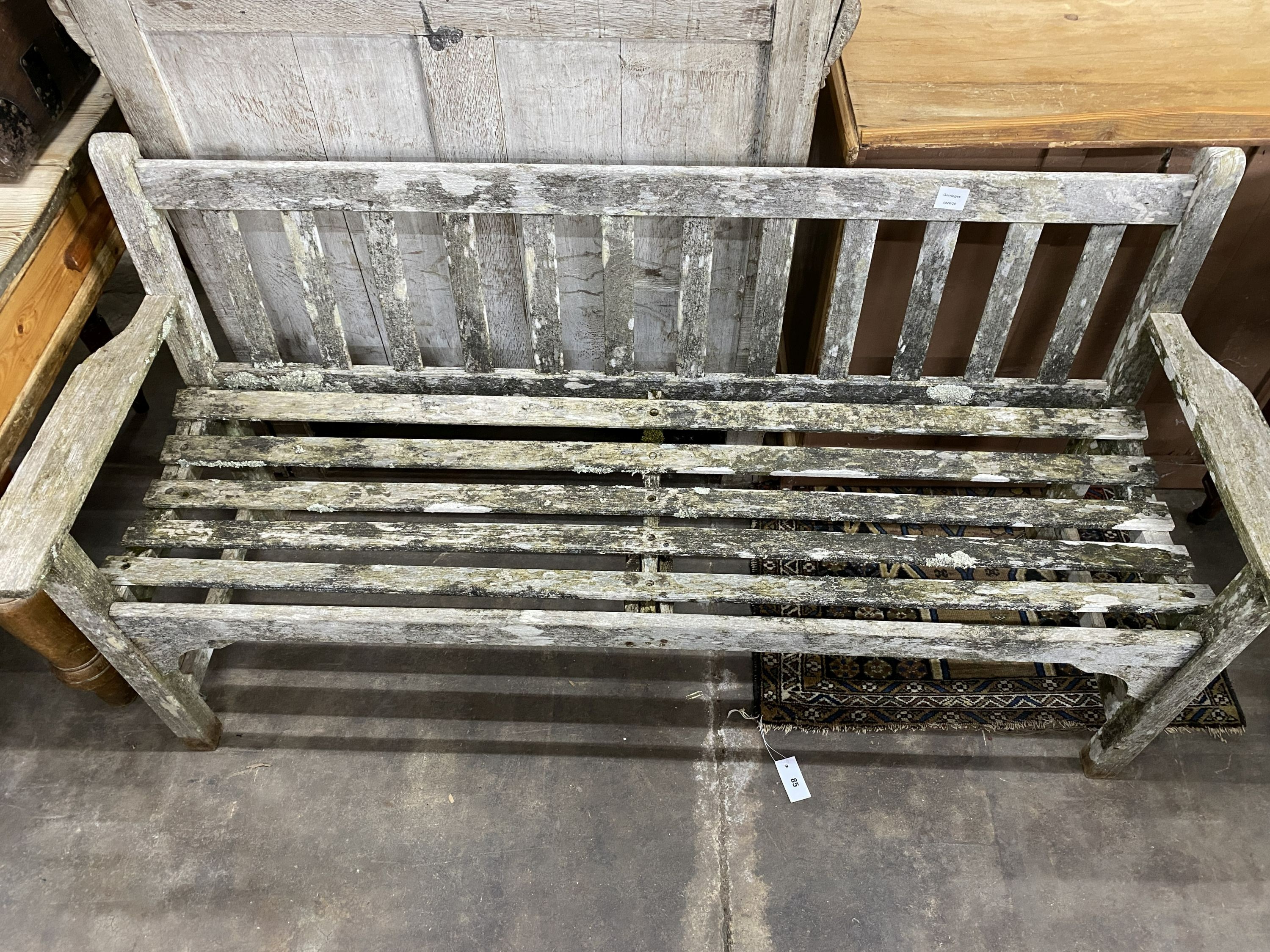 A weathered teak slatted garden bench, length 160cm, depth 54cm, height 82cm